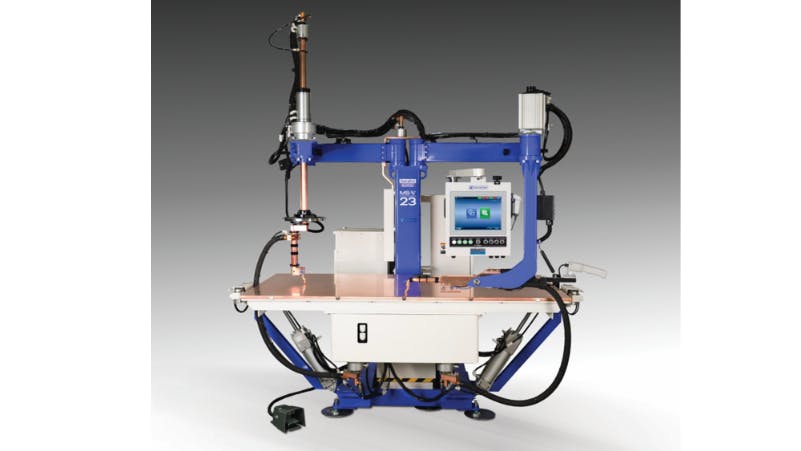 A piece of machinery with metal arms, a screen, and a table-like surface