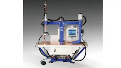 A piece of machinery with metal arms, a screen, and a table-like surface A piece of machinery with metal arms, a screen, and a table-like surface