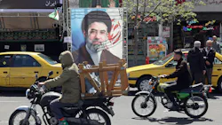 Two people riding bikes in the street of a city with businesses behind them Two people riding bikes in the street of a city with businesses behind them