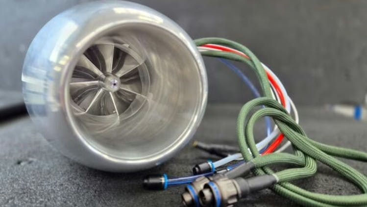 A close-up shot of an engine with cables sticking out of it