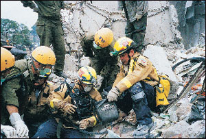 Fairfax County and Israeli firefighters use a search camera to hunt for victims in the Ufundi Building.