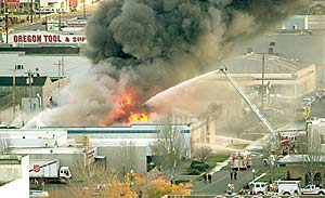 Firefighters from several departments pour water on the Farwest Truck