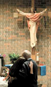 The funeral for firefighter Jonathan Myron Lamphear, who died Thursday on his way to a fire call, was Monday at St. Joseph&rsquo;s Catholic Church in Montevideo. His mother, Donna Freeman, and grandfather, Myron Nehring, console each other before the service.