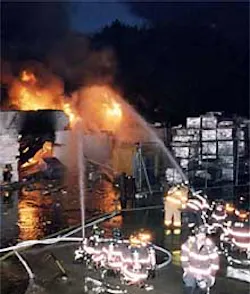 Firefighters battle a blaze at an Oceanside, L.I., cleaning plant yesterday morning after propane and acetylene tanks exploded. Firefighters battle a blaze at an Oceanside, L.I., cleaning plant yesterday morning after propane and acetylene tanks exploded.