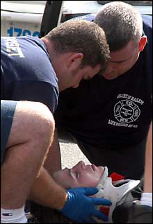FDNY rescuers put a neck brace on NY1 reporter Rebecca Spitz, whose skull was fractured by a van's mirror. She was on assignment at the time.