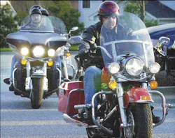 Jim Collins, founder of the Maryland chapter of the Red Knights, leads a group of fellow riders out of the Jim Collins, founder of the Maryland chapter of the Red Knights, leads a group of fellow riders out of the