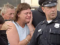 Mary Rodriguez, center, cries as she watches her mother's apartment go up in flames on Grove Street in Mechanicville on Wednesday, Aug. 4, 2004. Mary Rodriguez, center, cries as she watches her mother's apartment go up in flames on Grove Street in Mechanicville on Wednesday, Aug. 4, 2004.