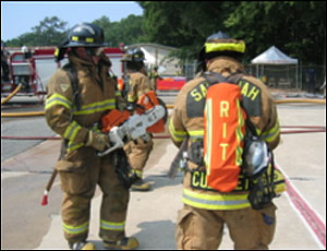 Assigned RIT personnel prepare to cut security bars to establish a secondary means of egress of interior crews.