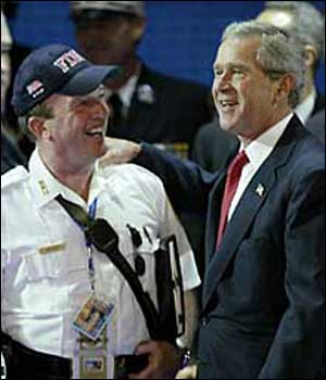 Fire Chief Harold Meyers &mdash; who carries a binder (right) printed with a quote from President Bush's 9/11 memorial speech &mdash; gets a pat from the man himself during preparations in the Garden yesterday.