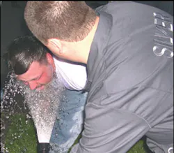 An OC pepper spray victim is rinsed with cool water from a garden hose. He will then be directed to dry himself with a clean cloth and report to paramedics for an evaluation. An OC pepper spray victim is rinsed with cool water from a garden hose. He will then be directed to dry himself with a clean cloth and report to paramedics for an evaluation.