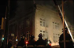 Knoxville Fire Department firefighters gather outside the Crimson building as smoke billows from the building in Knoxville, Tenn., Sunday, Feb. 27, 2005. Knoxville Fire Department firefighters gather outside the Crimson building as smoke billows from the building in Knoxville, Tenn., Sunday, Feb. 27, 2005.
