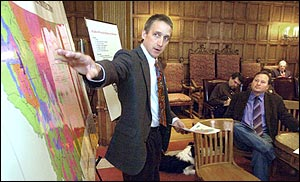 Bob Harrington, administrator for the Forestry Division of the Montana Department of Natural Resources Conservation briefs Gov. Brian Schweitzer, far right, during a fire and drought meeting in his Helena, Mont., office, Monday March 7, 2005. State officials assured Gov. Schweitzer that Montana will be prepared for what Schweitzer believes may be one of its worst wildfire seasons since 1988, when more than 2 million burned in the Northern Rockies. Hundreds of firefighters, together with helicopters and pumper trucks, are prepared, the officials said. But unknown is the possible impact of cuts in the U.S. Forest Service firefighting budget and availability of the large tanker aircraft for carrying fire retardant.