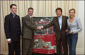 UFA President Steve Cassidy and Firefighter Brendan Cawley of Ladder 27 in the Bronx, who is recovering from a five-story jump that he and fellow firefighters had to make from a fire on Sunday, January 23rd, accepted the painting.