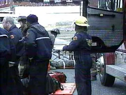 Firefighters being loaded into an ambulance. Firefighters being loaded into an ambulance.