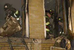 HEROES IN ACTION: Firefighters yesterday put out remnants of the fire, in which neighbors pitched in to pull the children to safety. HEROES IN ACTION: Firefighters yesterday put out remnants of the fire, in which neighbors pitched in to pull the children to safety.