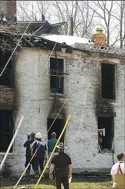 A firefighter sprays water on the roof of a house where a fire killed three people and injured two others near the campus of Miami University, Sunday, April 10, 2005, in Oxford, Ohio. (AP Photo/David Kohl) A firefighter sprays water on the roof of a house where a fire killed three people and injured two others near the campus of Miami University, Sunday, April 10, 2005, in Oxford, Ohio. (AP Photo/David Kohl)