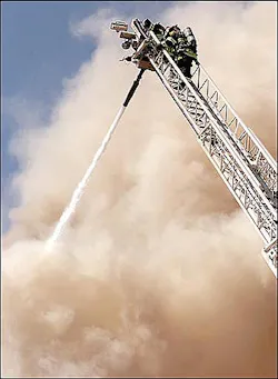Virginia firefighters direct a high pressure foam spray onto a blazing department store from an aerial truck Thursday, April 14, 2005, in Virginia, Minn. The fire completely destroyed the business. (AP Photo/Mesabi Daily News, Mark Sauer) Virginia firefighters direct a high pressure foam spray onto a blazing department store from an aerial truck Thursday, April 14, 2005, in Virginia, Minn. The fire completely destroyed the business. (AP Photo/Mesabi Daily News, Mark Sauer)