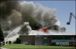 Firefighters spray water on Wasatch Junior High School as it burns in Salt Lake City, Monday, July 11, 2005. A six-alarm fire Monday destroyed the school, leaving officials scrambling to place 850 students for the fall term that starts in less than seven weeks.