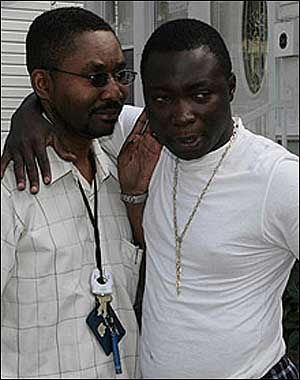 STILL IN SHOCK: Melvin Shephard is comforted by a pal yesterday outside the house where wife Melvina, daughter Alicia and his aunt died.