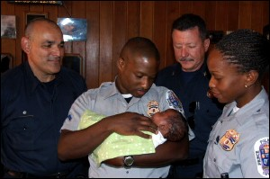 Fire Technician Hector Areizaga, Police Corporal Banks, Fire Captain Gigliotti and Police Officer Clarke with Baby Craig.