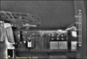 Prior to ladder or hose deployment, the first-in officer can see that heavy heat is building up underneath the truss roof of this Type III building. If there is no life-safety threat, this could dramatically alter the officer's strategy and tactics.