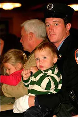 EXTENDED FAMILY: Firefighter Brendan Cawley yesterday with the family of John Bellew, who died in the line of duty. EXTENDED FAMILY: Firefighter Brendan Cawley yesterday with the family of John Bellew, who died in the line of duty.