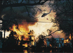 A helicopter makes a water drop on several dwellings. Extensive flooding barred apparatus from gaining access to the area.