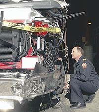 Burgess inspects extensive damage to a fire truck that was stolen while on a call Sunday morning. It will have to be repaired or replaced.
