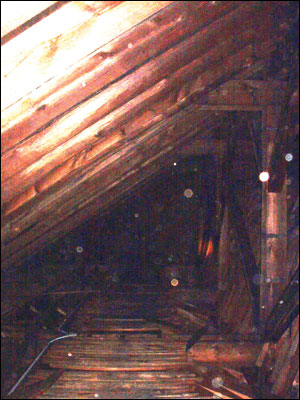 Photo 8. This photo shows how difficult it would be to not only find the fire, but a safe access route to the fire in the church without the use of the TIC. The camera enabled crews to &acirc;&euro;&oelig;see&acirc;&euro; the walkway and operate a line onto the burning bays of the cockloft.