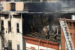 Firefighters stand on the roof of a damaged structure at the scene of an early morning apartment fire, in Union City, N.J., Saturday, Sept. 9, 2006. One firefighter was killed and four injured. Firefighters stand on the roof of a damaged structure at the scene of an early morning apartment fire, in Union City, N.J., Saturday, Sept. 9, 2006. One firefighter was killed and four injured.