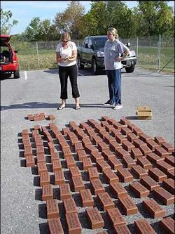 NFFF staff members, Judi Whitlow, left, and Rebecca Becker, left their desk jobs Tuesday to unpack and categorize engraved bricks before they are placed in the walk of honor. NFFF staff members, Judi Whitlow, left, and Rebecca Becker, left their desk jobs Tuesday to unpack and categorize engraved bricks before they are placed in the walk of honor.