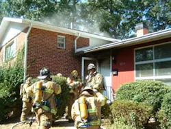 Photo 4. Volunteer Deputy Chief Charles Bailey and the first due companies prepare to enter the dwelling. Photo 4. Volunteer Deputy Chief Charles Bailey and the first due companies prepare to enter the dwelling.