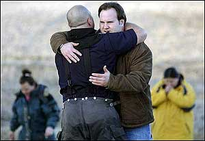 House resident Eddy Miller hugs a firefighter who had been working on the blaze.