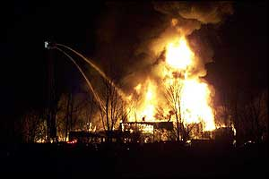 Firefighters pour water on the Great Lakes Skating Center in Ypsilanti Township, Mich., Jan. 25.