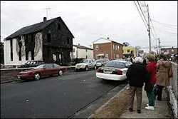 Neighbors look at the remains of a house in Manville, N.J. Neighbors look at the remains of a house in Manville, N.J.