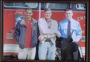 Michael French, far right, is congratulated by his uncle, Marvin Campbell, center, and Michael Campbell, his cousin.