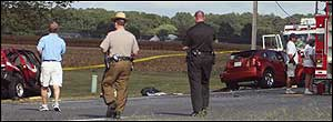 Accident scene investigators approach two vehicles, a Hebron Volunteer Fire Department SUV and a 4-door sedan, Sept. 9.