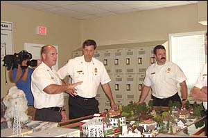 Charleston Chief Rusty Thomas, center, and Assistant Chief Robert O'Donald listen to Montgomery County Assistant Chief Greg DeHaven, far left, during training.