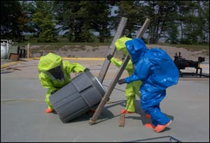 Photo 5: With the boards and ropes along side the drum that is nearly inside the overpack you can roll the whole unit into the saddle. It will then lower the drum into the overpack.