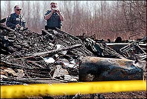 Investigators work at the scene of a fatal fire in Eastbrook on April 20 that killed the 13-year-old son of the local fire chief.