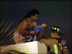 The father jumped to a neighboring building, with an infant in his arms, and waited to be rescued by firefighters. The father jumped to a neighboring building, with an infant in his arms, and waited to be rescued by firefighters.