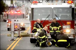 James Velasco, kneeling, and fellow firefighters rest after battling the blaze. James Velasco, kneeling, and fellow firefighters rest after battling the blaze.