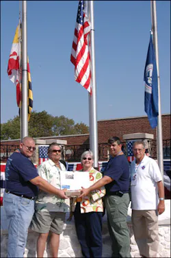 Brandon Thompson's brothers, Jeff, left, and Frank hold a brick from the Sofa Super Store while their parents, Frank Thompson and Diane White, hold an article about the deadly blaze. Retired New Bedford Chief Roger Nadeau assisted them this weekend. Brandon Thompson's brothers, Jeff, left, and Frank hold a brick from the Sofa Super Store while their parents, Frank Thompson and Diane White, hold an article about the deadly blaze. Retired New Bedford Chief Roger Nadeau assisted them this weekend.