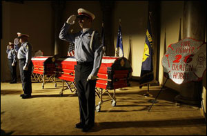 Houston Fire Department honor guard members Deena Elliott of Station 51, James Wathen of Station 15, and Chris Hamrick of Station 47, from left, salute before a public viewing for firefighters Capt. James Harlow and Damion Hobbs at Grace Community Church.