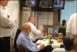 Dr. James Augustine, center background, makes a point Tuesday in the EMS command post. Dr. James Augustine, center background, makes a point Tuesday in the EMS command post.