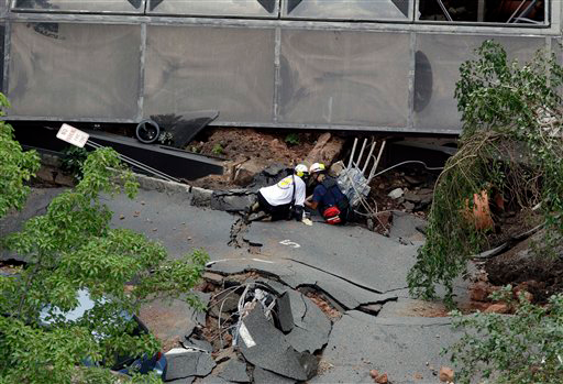 Rescue officials use electronic equipment to check for missing people.
