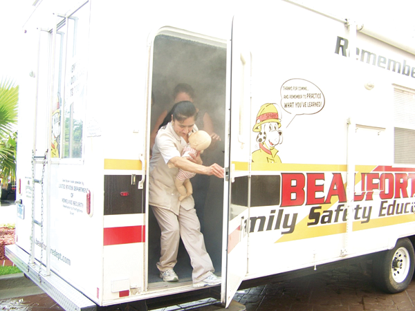 A team of hotel services staff negotiates a simulated fire situation involving reduced visibility.