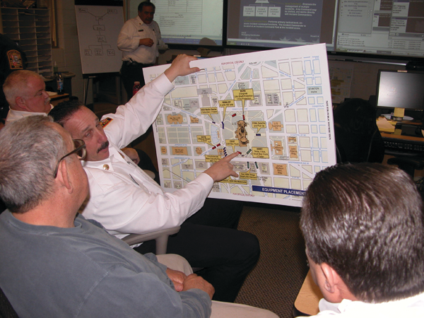 DCFD Assistant Chief Lawrence Schultz, center, meets with retired Phoenix Fire Chief Alan Brunacini, left in foreground, DCFD Chief Dennis L. Rubin and other fire-rescue officials during the operations of the President&rsquo;s 2009 State of the Union Address.