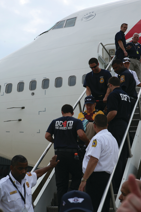 DCFD personnel assist the veterans upon their arrival in Washington, DC. They then boarded buses for the trip to the World War II Memorial.