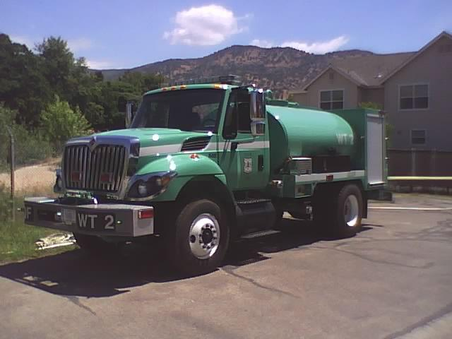 This is a Photo of new water tender 2. It is the new region 5 standard package. This water tender is classified as a type 2 tactical water tender, having a 1500 gallon tank, 25 gallon foam unit, and a Live reel. This water tender is stationed at the Scicon fire station on the Western Divide Ranger District. This is the only water tender on the Sequoia N.F.